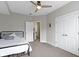 Well-lit bedroom with a ceiling fan, a comfortable bed, double doors, and ample closet space at 13048 Minden Dr, Fishers, IN 46037