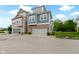 Exterior view of modern two-story townhomes featuring brick accents and attached garages in a suburban setting at 13048 Minden Dr, Fishers, IN 46037