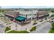 Beautiful exterior of the Bonn Building featuring a pizzeria, outdoor seating, and lush landscaping at 13048 Minden Dr, Fishers, IN 46037