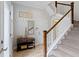 Welcoming hallway with staircase, coat rack, and tiled floors at 13048 Minden Dr, Fishers, IN 46037