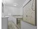 Modern bathroom with stylish stone shower, soaking tub, and neutral-toned tile flooring at 1311 N Eaton Ave, Indianapolis, IN 46219