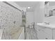 Elegant bathroom featuring stone shower, floating shelves, and sleek fixtures for a modern aesthetic at 1311 N Eaton Ave, Indianapolis, IN 46219