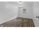 Bedroom featuring wood-style floors and a window with neighborhood views at 1311 N Eaton Ave, Indianapolis, IN 46219