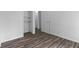 Bedroom with open closet space and wood-look laminate flooring at 1311 N Eaton Ave, Indianapolis, IN 46219