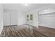 Spacious bedroom with new wood flooring, walk-in closet, and glass doors to the backyard at 1311 N Eaton Ave, Indianapolis, IN 46219