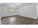 Cozy bedroom with laminate flooring and a window view at 1311 N Eaton Ave, Indianapolis, IN 46219