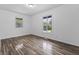 Bright bedroom with wood-style floors, window and closet space at 1311 N Eaton Ave, Indianapolis, IN 46219