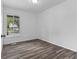 Well-lit bedroom with wood-look flooring and a large window at 1311 N Eaton Ave, Indianapolis, IN 46219