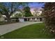 Charming single-story home with stone accents, a spacious driveway, and lush green lawn at 1311 N Eaton Ave, Indianapolis, IN 46219