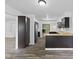 Open kitchen layout with dark cabinets, wood countertops, and a clear view into the living area at 1311 N Eaton Ave, Indianapolis, IN 46219