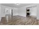 Open living area with wood floors leads to the kitchen and entryway at 1311 N Eaton Ave, Indianapolis, IN 46219
