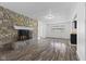 Open-concept living room features new flooring, a stone fireplace, and ample natural light at 1311 N Eaton Ave, Indianapolis, IN 46219