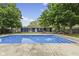 In-ground pool that is surrounded by a concrete deck and the home in the background at 1311 N Eaton Ave, Indianapolis, IN 46219