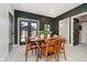 Inviting dining room with hardwood table, modern light fixtures, and access to the backyard through glass doors at 1318 Hoyt Ave, Indianapolis, IN 46203