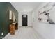 Inviting entryway with light wood floors, black door, neutral decor, and stylish accents at 1318 Hoyt Ave, Indianapolis, IN 46203