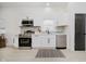 Well-lit kitchen with stainless steel appliances, subway tile backsplash, and ample counter space at 1318 Hoyt Ave, Indianapolis, IN 46203