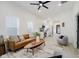 Bright and airy living room with modern furnishings, ceiling fan, open floor plan, and natural light at 1318 Hoyt Ave, Indianapolis, IN 46203