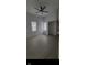 Light-filled living room features modern flooring, new paint, fan, and windows at 1318 Hoyt Ave, Indianapolis, IN 46203
