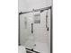 Modern bathroom shower with white subway tiles, rainfall shower head and sleek glass door at 1318 Hoyt Ave, Indianapolis, IN 46203