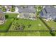 Aerial view of a large, fenced backyard with lush lawn, patio, and mature trees at 13485 Mancroft Dr, Fishers, IN 46037
