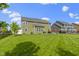 Large backyard with a manicured lawn, mature trees, and a privacy fence, providing ample space for recreation at 13485 Mancroft Dr, Fishers, IN 46037