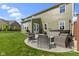 Spacious backyard with a patio, seating area, and manicured lawn, ideal for outdoor gatherings and relaxation at 13485 Mancroft Dr, Fishers, IN 46037