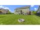 Spacious backyard featuring a fire pit, lush lawn, and a charming patio at 13485 Mancroft Dr, Fishers, IN 46037