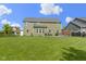 Expansive backyard with a lush lawn, privacy fence, and well-kept landscaping, creating a serene outdoor oasis at 13485 Mancroft Dr, Fishers, IN 46037