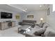 Basement living area with comfortable gray couches and a mounted television at 13485 Mancroft Dr, Fishers, IN 46037