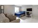 Cozy basement bedroom with comfortable sofa, television, and a desk at 13485 Mancroft Dr, Fishers, IN 46037