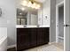 Bathroom featuring a double sink vanity, a large mirror, and a shower-tub combo at 13485 Mancroft Dr, Fishers, IN 46037