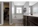Bathroom boasting a soaking tub, double vanity with bronze fixtures, and a walk-in closet at 13485 Mancroft Dr, Fishers, IN 46037