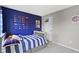 Youthful bedroom features sports-themed decor, gray walls, and a cozy bed at 13485 Mancroft Dr, Fishers, IN 46037