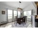 Bright dining room featuring a large wooden table, stylish light fixture, and ample natural light at 13485 Mancroft Dr, Fishers, IN 46037