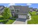Beautiful two-story home with stone accents, a well-manicured lawn, and an attached two-car garage at 13485 Mancroft Dr, Fishers, IN 46037
