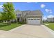 Charming two-story home with stone and siding, showcasing a well-maintained lawn and driveway at 13485 Mancroft Dr, Fishers, IN 46037