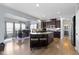 A modern kitchen features dark wood cabinets, stainless steel appliances, and an island with breakfast bar at 13485 Mancroft Dr, Fishers, IN 46037