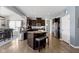 A modern kitchen features dark wood cabinets, stainless steel appliances, and an island with breakfast bar at 13485 Mancroft Dr, Fishers, IN 46037