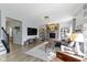 Spacious living room with stone fireplace, modern furnishings, and plenty of natural light at 13485 Mancroft Dr, Fishers, IN 46037