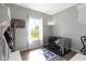 Bright room featuring neutral walls, wood floors, large window, and a dog crate at 13485 Mancroft Dr, Fishers, IN 46037