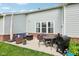 Inviting patio with wicker furniture, a dining table, grill, and view of the backyard at 14458 Carlow Run, Carmel, IN 46074