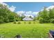 Expansive lawn in backyard, ideal for outdoor activities, bordered by mature trees and landscaping at 14458 Carlow Run, Carmel, IN 46074