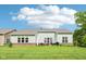 Spacious backyard with patio furniture, green lawn, and view of the home's rear facade at 14458 Carlow Run, Carmel, IN 46074
