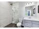 Modern bathroom featuring a glass-enclosed shower with rainfall showerhead and gray vanity with white countertop at 14458 Carlow Run, Carmel, IN 46074