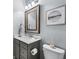 Powder room featuring a decorative mirror, quartz countertop, and tile floors at 14458 Carlow Run, Carmel, IN 46074