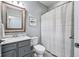 Bathroom featuring a vanity with a decorative mirror and a shower with a patterned curtain at 14458 Carlow Run, Carmel, IN 46074