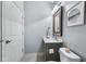 Powder room featuring a decorative mirror, quartz countertop, and tile floors at 14458 Carlow Run, Carmel, IN 46074