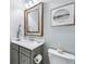 Powder room featuring a decorative mirror, quartz countertop, and tile floors at 14458 Carlow Run, Carmel, IN 46074
