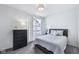 Cozy bedroom featuring modern decor, a dresser, a lamp, and a comfortable bed at 14458 Carlow Run, Carmel, IN 46074