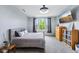 Cozy bedroom with a gray bed, a window view, television, and neutral decor at 14458 Carlow Run, Carmel, IN 46074
